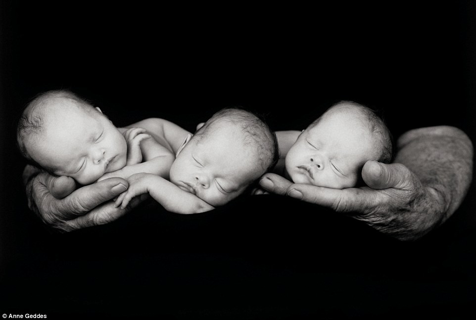 Three snoozing triplets rest in their father
