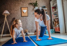 Mother and daughter on exercise mats