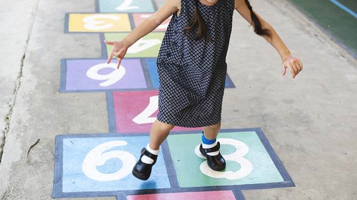 The girl playing hopscotch
